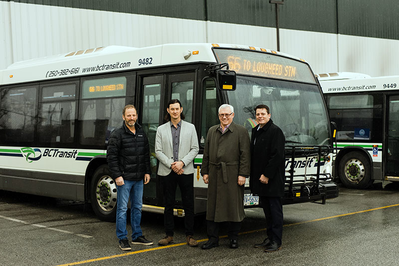 Jason Lum, Chair of FVRD Board and local government partners stands in front of a FVX bus